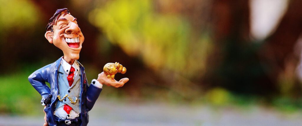 a smiling business man showing off the golden elephant that he has